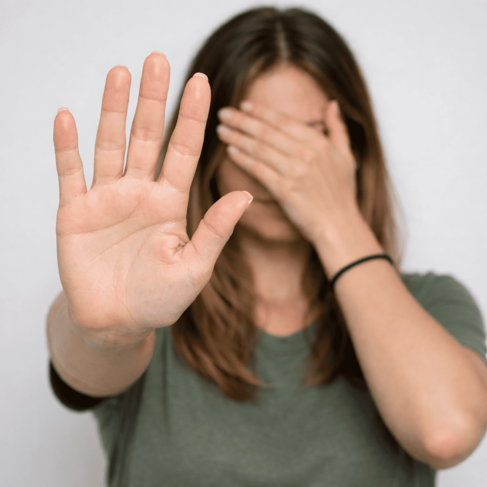 A victim of domestic abuse lady holding hand up to stay stop