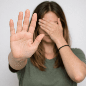 A victim of domestic abuse lady holding hand up to stay stop